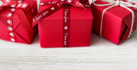 Red gift boxes on a white wood background. Valentine's day banner