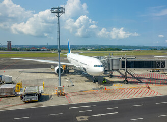 Airplane in Indonesian Airport With Jet Bridge for Passengers