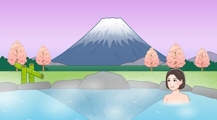 富士山が見えるところで温泉に入っている女性