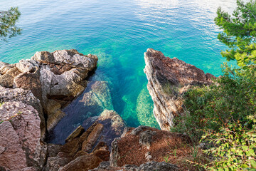 Rocky coast of the sea, azure turquoise clear water, aerial view.