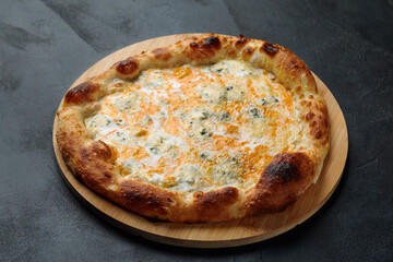 Italian Pizza Quattro formaggi. Italian pizza on dark stone background