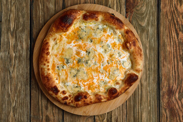 Italian Pizza Quattro formaggi. Italian pizza on wooden background