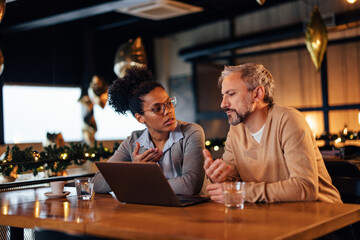 Confident African-American woman, sharing her ideas with her coworker.