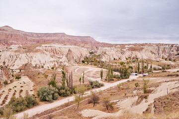 Travel and tourism in Turkey. Famous sightseeing Cappadocia, Anatolia. Beautiful landscape with mountains, caves and cloudy sky.