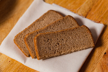 pieces of rye bread on a wooden background