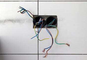  electrical wires protruding from the Wall