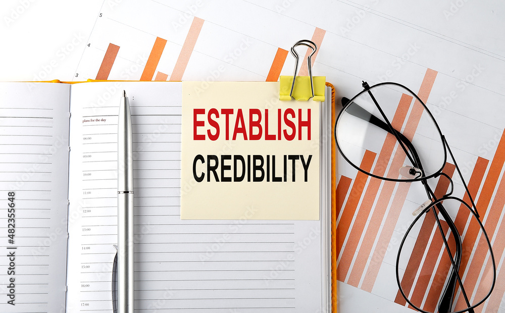 Poster text establish credibility on sticker on the notepad on diagram background