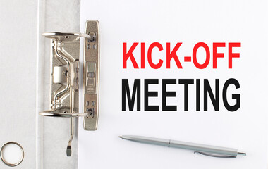 KICK-OFF MEETING text on the paper folder with pen. Business concept