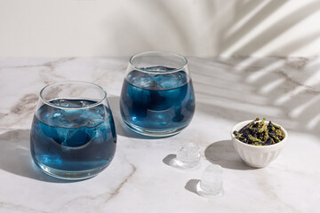 Two glasses of anchan from butterfly pea flower, iced blue tea.