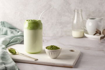 Homemade dalgona matcha latte, and spoon of green tea powder. - obrazy, fototapety, plakaty
