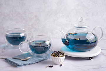 Blue tea in glass cups and teapot, anchan from dry butterfly pea flower.