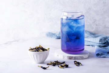 Iced butterfly pea flower tea and dry clitoria ternatea petals, blue anchan.