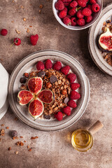 Chocolate granola with almond milk, raspberries, figs and honey.