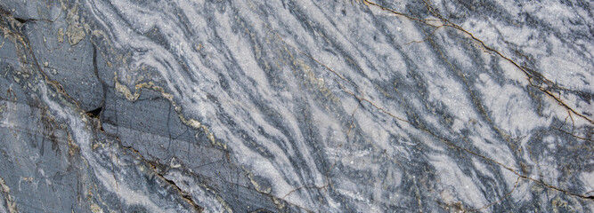 Gray patterned natural of dark raw marble texture background. Texture of raw stone, marble in natural light. Rough natural background.