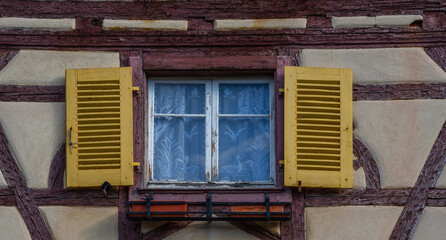 Old house wall with windows and dark timber. Front view of traditional half timbered houses with...
