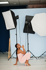 Fashionable photo of young beautiful romantic african american woman with glass of wine, wearing pink dress. Studio shoot.