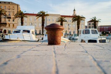 Fototapeta na wymiar Iron bollard for mooring of ships at pier. Landscape with sea wharf. Split, Croatia.
