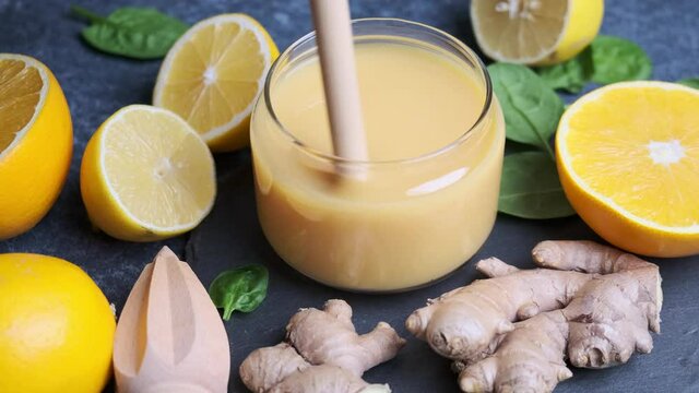 Ginger and orange juice for immunity. Fruit smoothie in a glass and ingredients.