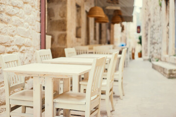 Fototapeta na wymiar The wooden table in sidewalk cafe.