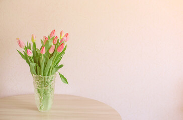 A bouquet of colorful spring tulips wrapped in a craft paper