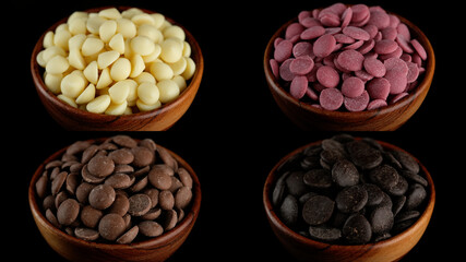 Different types of chocolate in wooden bowl White, ruby, milk, dark chocolate chips