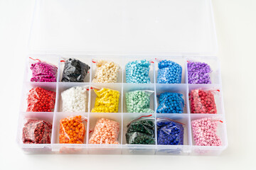 colorful beads in the container with cells. set for creativity and needlework. Convenient storage...