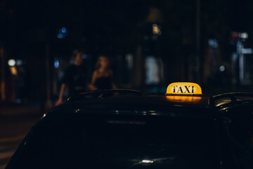 Glowing taxi sign at night in the city close-up