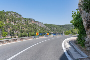 A road with sharp turns in the mountains. Serpentine highway. Skradin, Croatia.