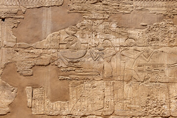 Relief details and Egyptian hieroglyphs at Karnak temple complex in Luxor