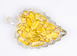 pills of fish oil capsules on glass plate. Top view. ,