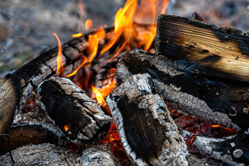 burning log of wood close-up as abstract background, the hot embers of burning wood log fire