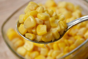 steamed sweet corn seed in salt water on spoon