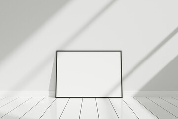 Minimalist and clean horizontal black poster or photo frame mockup on the floor leaning against the room wall with shadow