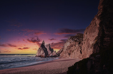 Cliffs and rocks on the Atlantic ocean coast - Praia da Ursa beach, Portugal on sunset.