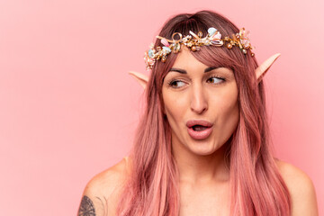 Young caucasian elf woman isolated on pink background