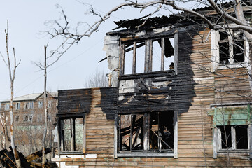 The old wooden burned-down house front view
