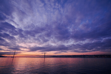 Fototapeta premium Beautiful landscape with suspension 25 April bridge bridge over the Tagus river in Lisbon at sunset.