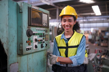 Factory Female Industrial Engineer Works in metal working factory, Inside the Heavy Industry. Portrait of working female industry technical worker or engineer woman working in an industrial.