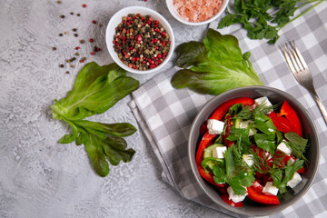 Salad of fresh vegetables with herbs and feta cheese. Healthy food rich in vitamins, fiber, antioxidants.