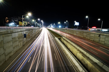 Fototapeta na wymiar Night traffic junction road with lights of vehicle movement. Horizontal view