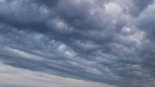 Amazing fluffy clouds floating the sky going to darkness