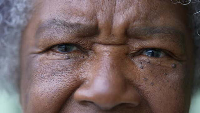 A senior woman macro closeup face eyes looking at camera