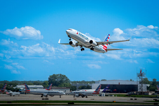 Charlotte, NC—April 30, 2019; American Airlines flight taking off from runway with parked regional jets in the background.