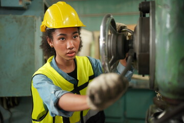 Female apprentice in metal working factory, Portrait of working female industry technical worker or...