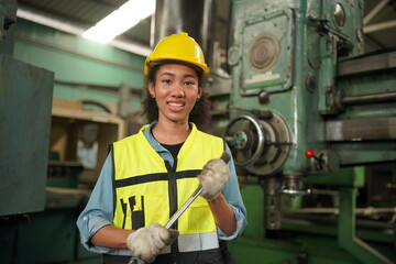 Female apprentice in metal working factory, Portrait of working female industry technical worker or engineer woman working in an industrial manufacturing factory company.