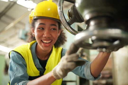 Female Apprentice In Metal Working Factory, Portrait Of Working Female Industry Technical Worker Or Engineer Woman Working In An Industrial Manufacturing Factory Company.