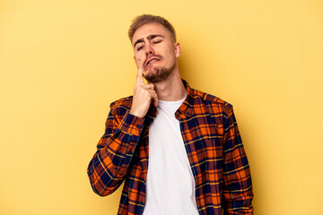 Fototapeta premium Young caucasian man isolated on yellow background crying, unhappy with something, agony and confusion concept.