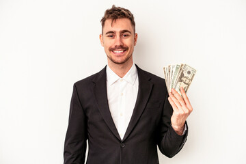 Young caucasian business man holding bank notes isolated on white background happy, smiling and cheerful.