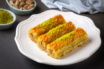 Turkish famous dessert burma kadayif on plate with pistachio