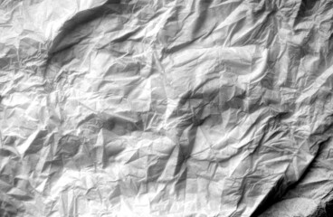 Crumpled white paper background in black and white.